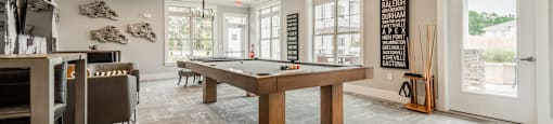 a game room with a pool table and a bar