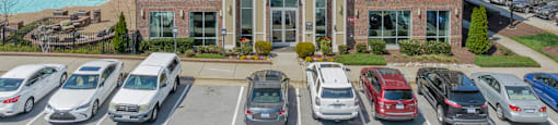 a large apartment building with a parking lot in front of it