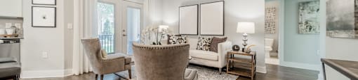 a living room with furniture and a ceiling fan