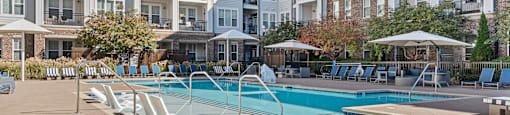 A large swimming pool surrounded by apartment buildings.