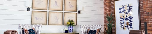 A room with a white wall and a brown chair.