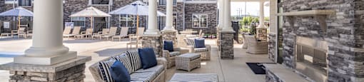 the preserve at ballantyne commons covered patio with couches and a fireplace