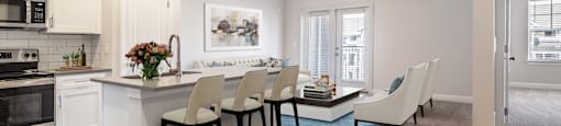 an open kitchen and living room with a dining table and chairs
