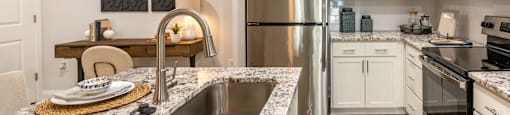 a kitchen with granite counter tops and stainless steel appliances