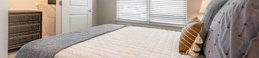a bedroom with a large bed and a door to a bathroom