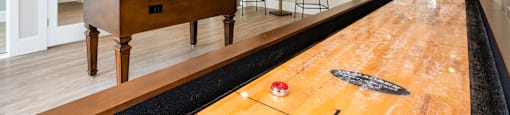 a game room with a pool table and a tv