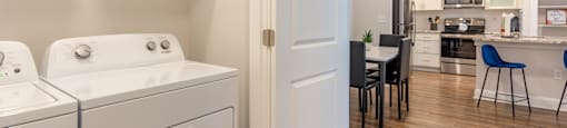 a washer and dryer in a room with a kitchen and a dining room