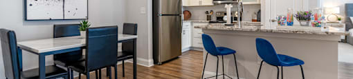 a kitchen and dining area with a table and chairs