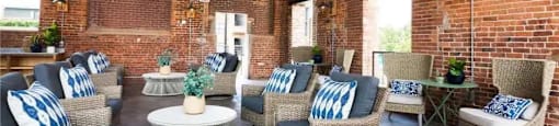 A room with brick walls and ceiling fans.