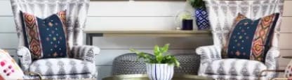 A living room with a white wall and a set of four pictures on it.