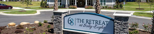 the retreat at sleepy edge apartments sign in front of building