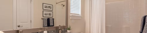 a bathroom with two sinks and a shower and a toilet