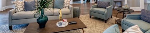 a living room with couches and chairs and a table