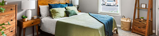 a bedroom with a bed and a window