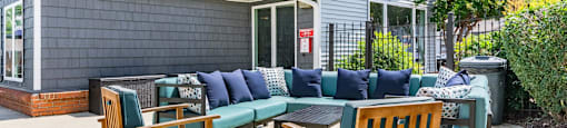 a patio with a table and chairs and a house