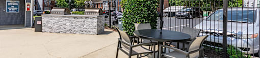 a patio with a table with chairs and an umbrella