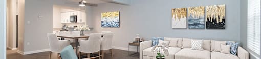 A living room with a dining table and chairs.