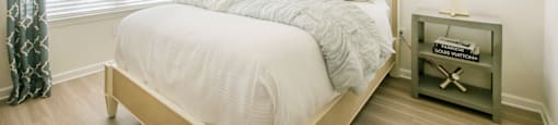 a bedroom with a bed and a ceiling fan