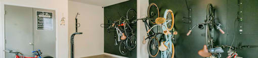 a room with bikes on the wall and a wood floor