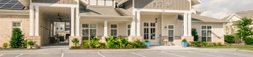 the front of a building with a parking lot