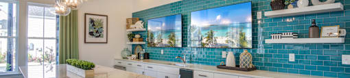 a kitchen with blue tiles and a white counter top