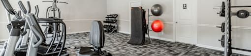 A well-equipped gym with a variety of exercise equipment at Enclave at 38 Twenty Two Apartments in Greensboro, NC