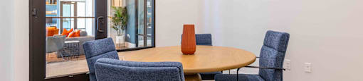 a dining room with a table and four chairs