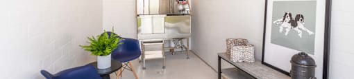 the living room of a home with blue chairs and a desk