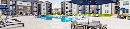 our apartments offer a swimming pool with tables and umbrellas