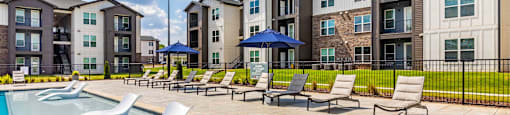 our apartments offer a swimming pool with lounge chairs and umbrellas
