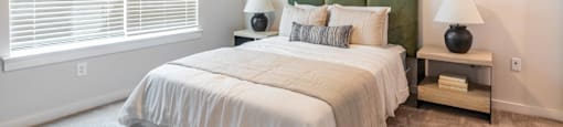 a bedroom with a large bed and a ceiling fan