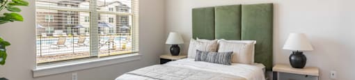 a bedroom with a large bed and a ceiling fan