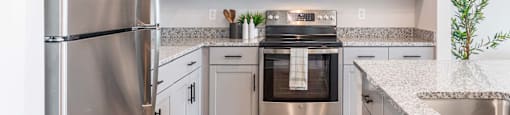a kitchen with white cabinets and stainless steel appliances