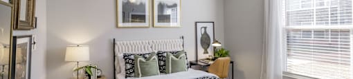 a bedroom with a bed and a ceiling fan