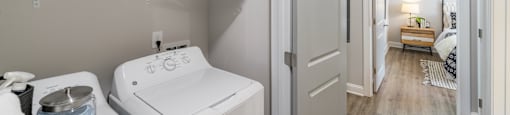 a white room with two beds and a sink in it