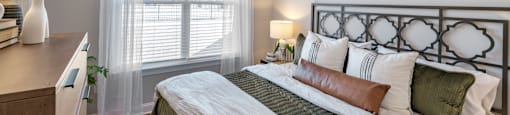 Large bedroom with green and white bed