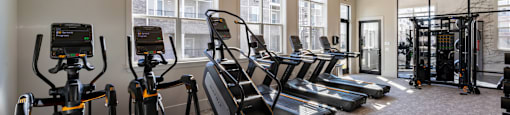 the gym with cardio equipment at the preserve at polk apartments