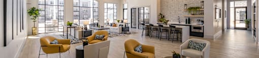 Large clubhouse with vaulted ceilings and yellow chaits