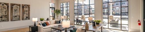 an open living room with couches and a dining room table