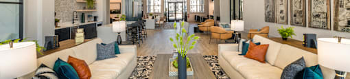 A spacious clubhouse with a central coffee table and a large sofa.