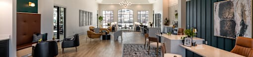 a large lobby with chairs and tables and a fireplace