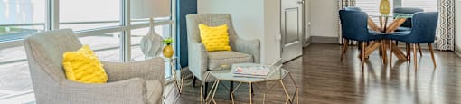 a living room with chairs and a table