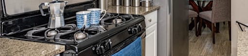 a kitchen with a stove and a microwave and a refrigerator