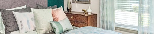 a bedroom with green walls and a bed with pillows