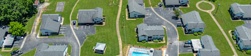 an aerial view of several mobile homes in a neighborhood with a swimming pool
