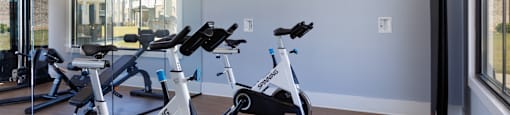 A Spinning bike is in a well lit room.