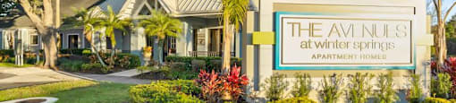 the sign in front of a building with palm trees
