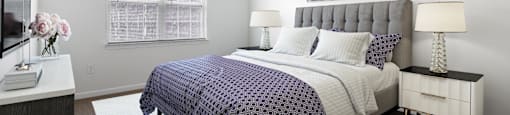 a bedroom with a bed and a ceiling fan
