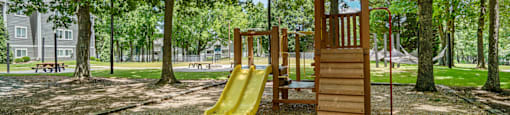 a playground with a wooden tower with a clock on it