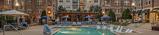A large swimming pool in front of apartment buildings.